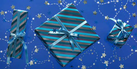 Christmas gift boxes and decorations on blue background