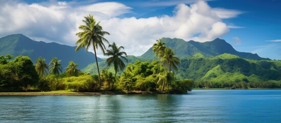 In the tropical summer as I travel I am in awe of the breathtaking landscape that surrounds me the lush green forest towering mountains and vibrant blue sky reflecting in the calm waters bel