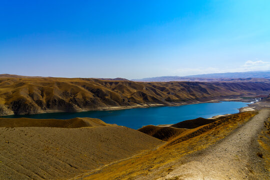 A deserted part of the Zaamin nature reserve in Uzbukistan on a sunny summer day. View of the mountains and reservoir.