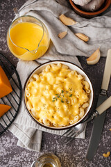 Bowl of tasty Italian pasta with Cheddar cheese on grunge background