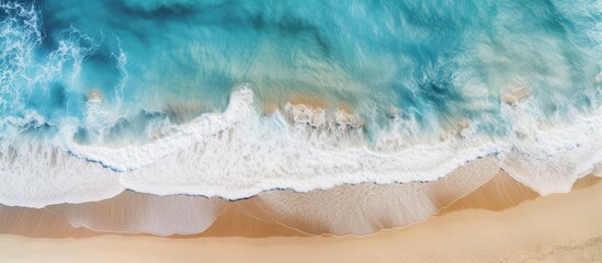 In the aerial photograph the breathtaking beach landscape with its azure waves crashing against the...
