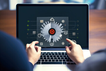 Photo of a person working on a laptop with a clock displayed on the screen