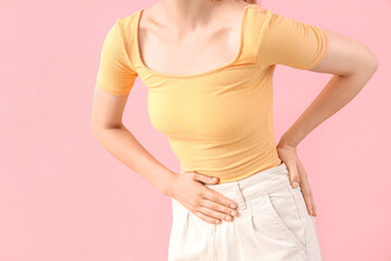 Young woman suffering from stomach ache on pink background, closeup - obrazy, fototapety, plakaty