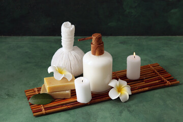 Set of spa supplies on green background