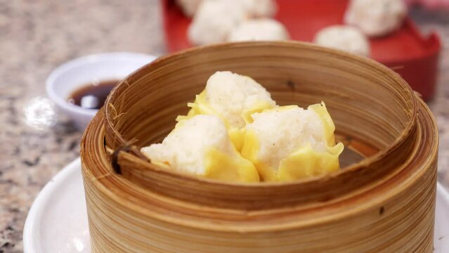 Thai steamed dumplings gently cooked in bamboo steamer served in a plate,