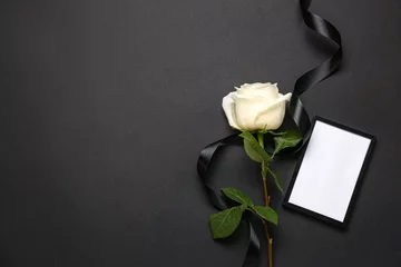 Foto op Aluminium White rose with ribbon and photo frame on black background © Pixel-Shot