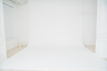 A photo studio with a white cyclorama for a professional photo shoot. 