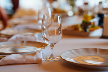 An empty wine glass on a table served for a banquet. 