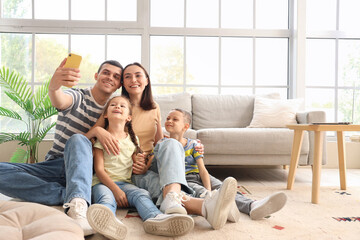 Happy family taking selfie at home