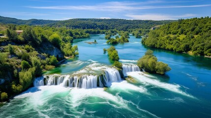 Fototapeta na wymiar Krka, Croatia - Aerial view of the beautiful Krka Waterfalls in Krka National Park on a bright summer morning with green foliage, turquoise water and blue sky