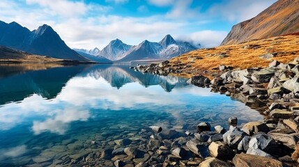 Landscape of lake Tahtarjavr with transparent water, rocky bottom and distant mountains reflected in still morning waters, Hibiny mountains above the Arctic circle, Russia