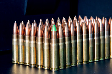 bullets on dark, bullets on the table, the first bullet is green and he is the commander, abstract photo, market, 