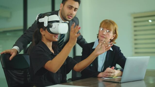 Diver business people working at office. Beautiful indian girl wearing virtual reality headset. Woman playing using VR goggles at office.