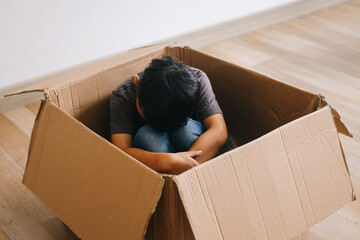 Sad little kid sitting lonely in the box
