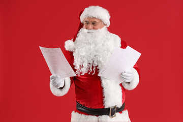 Santa Claus with letters on red background