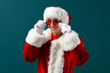 Santa Claus in glasses on dark green background
