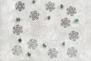 Frame made of beautiful snowflakes and fir branches on grunge grey background