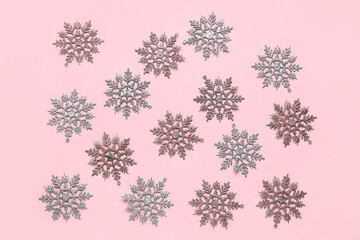 Many beautiful snowflakes on pink background