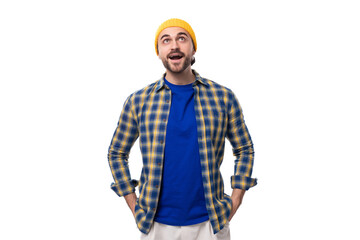 handsome young male hipster in cap and shirt surprised on white background with copy space