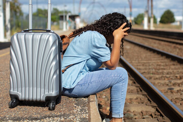 women traveler bored waiting for train in the station