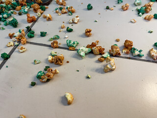 Popcorn scattered on the floor. The concept of eating popcorn.