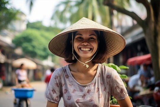 Asian woman wearing a hat in the street of Hoi An, Vietnam