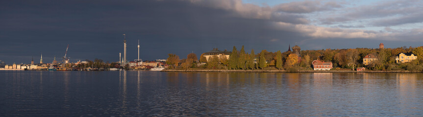 Fototapeta na wymiar Panorama over the bay Strömmen and the Vasa depth, grey sky back ground and low morning sun light, early autumn morning in Stockholm