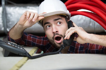 shocked young man technician on the phone