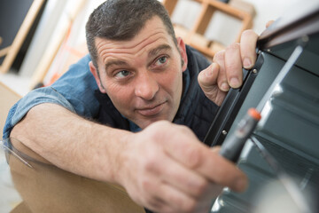 workman assembling an electric oven