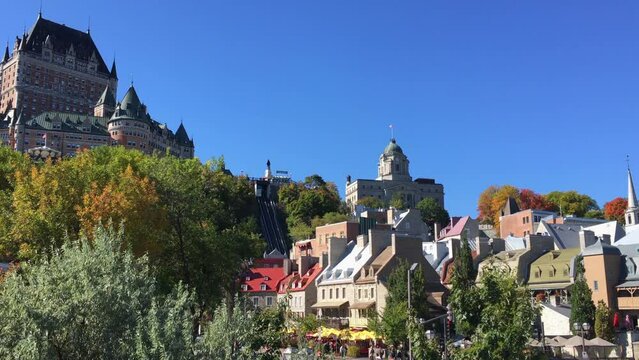 Activity in the colorful and quant Petit Champlain historic district below the Chateau Frontenac in Quebec City. Breezy sunny, blue skies.