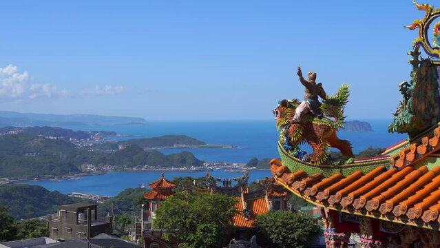 Incredible view out on blue sea from high above with Chinese temple