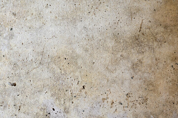 An old wall with a cracked texture is decorated with cement mortar