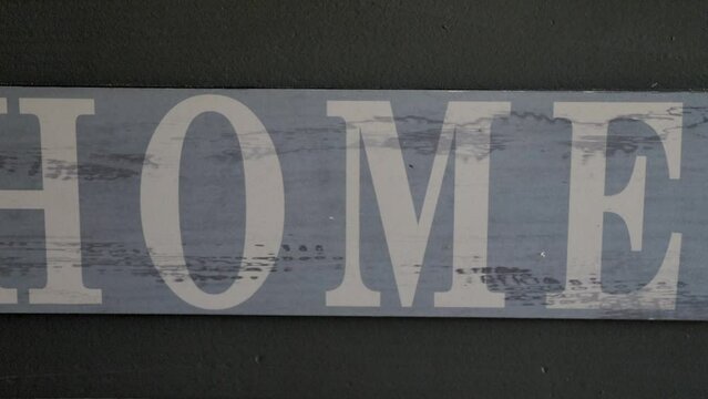 Close up colorful writing "Home" on wooden board. Blurred effect. Video 4K