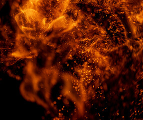 Fototapeta na wymiar fire flame with sparks on black background.