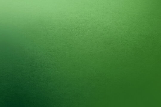 Dark solid green tone color gradation pale light emerald green paint on environmental friendly cardboard box blank paper texture background with space minimal style