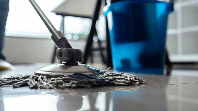 Asian cleaning service housekeeper women swipe floor in office
