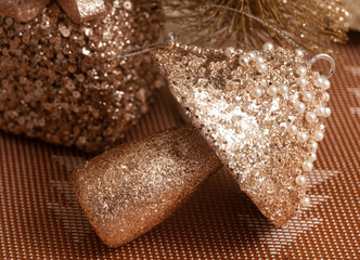 Golden Christmas ornament of a sparkling gift and mushroom 

