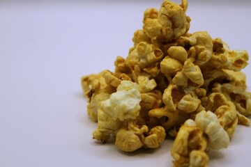 Popcorn isolated on white background, closeup of a pile of popcorn