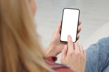 Woman using smartphone at home, closeup. Space for text