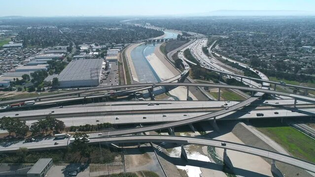 Aerial drone shot of 710 Interstate over the LA River in California with cars on highway