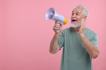 Special promotion. Senior man shouting in megaphone on pink background. Space for text