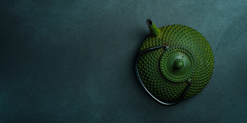Traditional Japanese teapot for brewing tea. On a black stone background. Top view. Free space for...