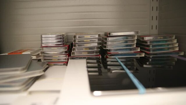 Technology boxes stacked on a shelf in an office.