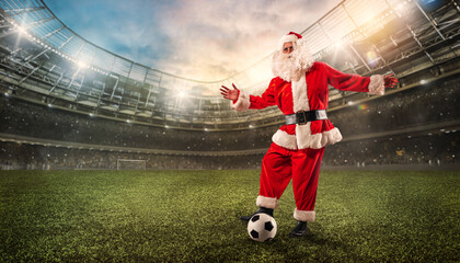 Santa claus ready to play football with soccerball