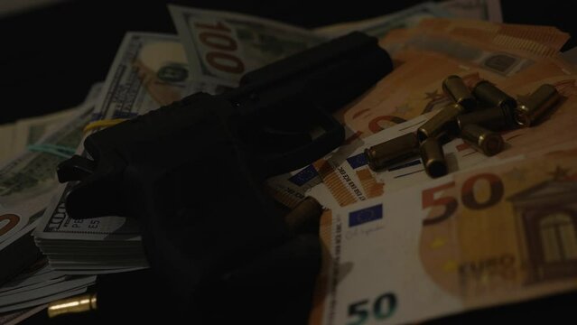 Physical evidence of a crime in the form of a firearm and dollar cash in the light of flashes of police lights