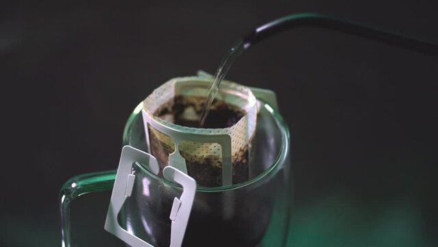 Drip coffee and pour water on the black stone table, soft focus.shallow focus effect.