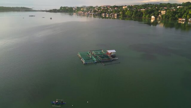 Fishpen cage farming in clear water coastline during sunrise, Philippines