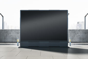 Empty wide black outdoor billboard screen on bright city background. Advertisement and commercial...
