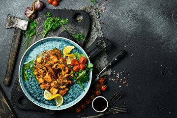 Pieces of sturgeon stewed with vegetables. Fish menu. Free space for text. Close up.