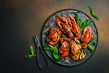 Boiled Serrated mud crab and crayfish on black plate on black background. Seafood. Recipe.